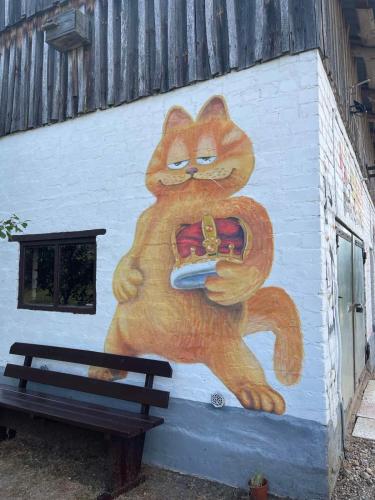 a painting of a cat holding a cell phone at Česlovos sodyba in Zarasai