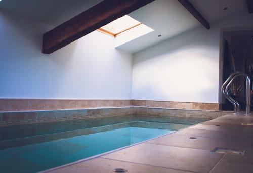 a swimming pool in a room with a skylight at Valley View Pendle in Foulridge