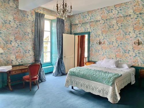 a bedroom with a bed and a desk at L'Hotel de Hercé Chambre d'Hote in Mayenne