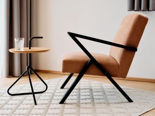a chair and a table in a room at ARX Guesthouse in Schladming