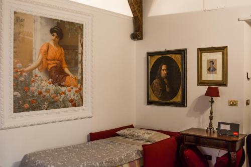 a room with two beds and a painting on the wall at Flora in Rome