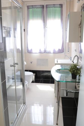 a bathroom with a shower and a sink and a toilet at GUEST HOUSE SIMONAZZI in Reggio Emilia