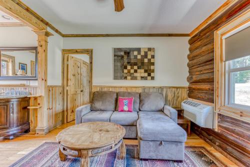 a living room with a couch and a table at The Logs Bear Cave in Snowden