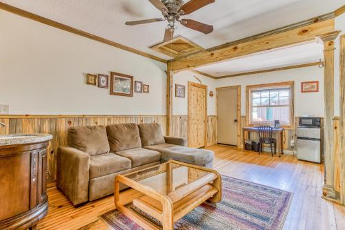 a living room with a couch and a table at The Logs Birds Paradise in Snowden