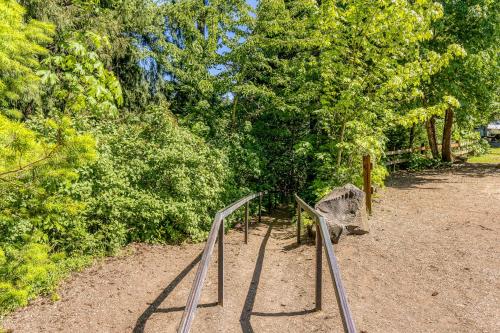 a path in a park with a fence and trees at The Logs Bear Cave in Snowden