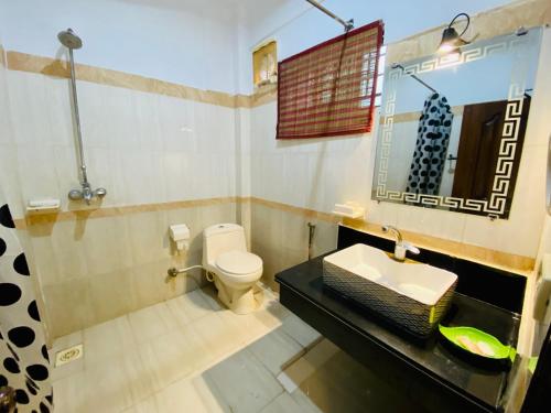a bathroom with a toilet and a sink at Fiesta Inn Hotel & Resorts Multan in Multan