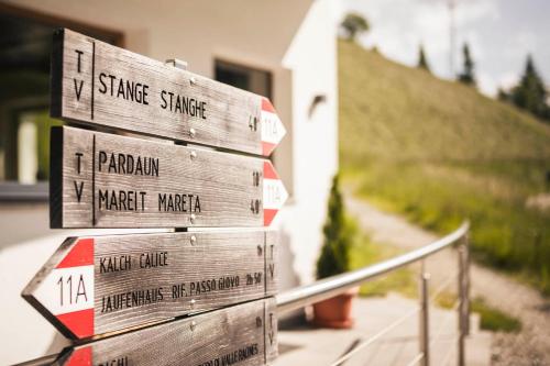a stack of wooden signs next to a house at Gasthof Jaufensteg in Racines