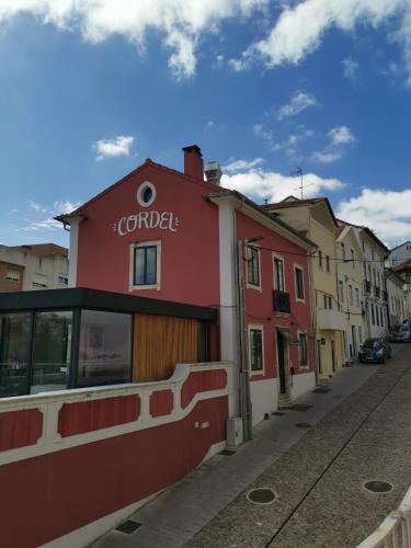 a red building on the side of a street at Casa do Convento AL/141600 in Coimbra