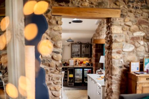 a kitchen with a stone wall and a counter at 1692 Wasdale in Gosforth