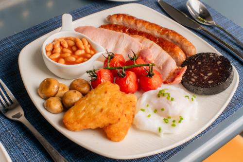 a plate of food with eggs bacon tomatoes and other foods at 1692 Wasdale in Gosforth