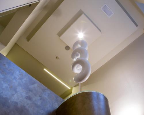 a sculpture hanging from the ceiling of a room at Best Western Madison Hotel in Milan