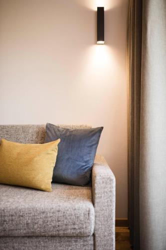 a couch with two pillows on it next to a light at Gasthof Jaufensteg in Racines