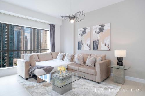 a living room with a couch and a table at LUX The Luxurious Central JBR Suite in Dubai