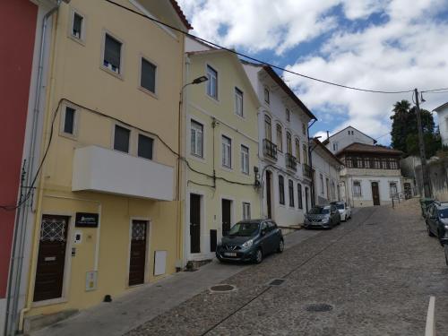 a street with cars parked next to buildings at Casa do Convento AL/141600 in Coimbra