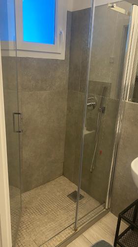 a shower with a glass door in a bathroom at Grey House Guest House Luxury in Latina
