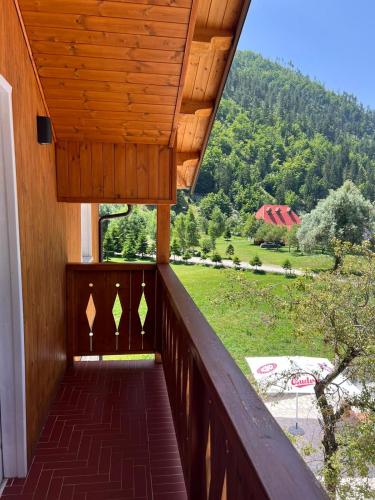 a wooden balcony with a view of a mountain at Oda N'Bjeshke in Valbonë
