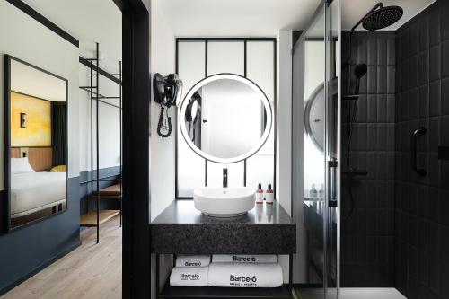 a bathroom with a sink and a mirror at Barceló Warsaw Powiśle in Warsaw
