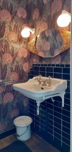 a bathroom with a sink and a toilet at Maison blanche in Cherval