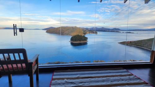 a large window with a view of a large body of water at Inti Illimani Lodge in Comunidad Yumani