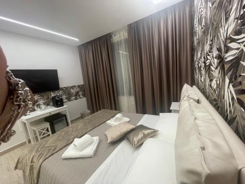 a bedroom with a large bed and a television at Bobbio Holiday Rome in Rome