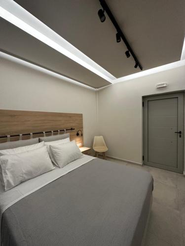 a bedroom with a large bed and a sliding door at Aktaion Rooms in Stoupa