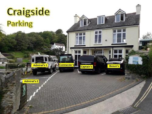 a group of vehicles parked in front of a house at Bosons Bunks 'As seen in Beyond Paradise ' in Looe