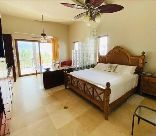 a bedroom with a bed and a ceiling fan at Beachfront Condo directly on the private beach - Ground Floor in Six Huts