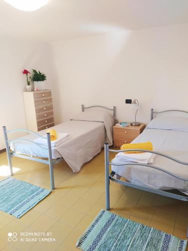 a bedroom with two beds and a dresser at La Chicca 5 posti letto in Capannori