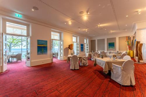 a large banquet room with tables and chairs at Beau Rivage Hotel in Neuchâtel