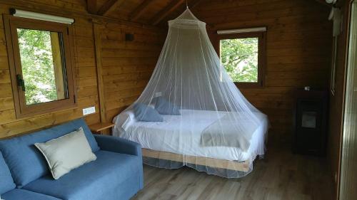a bedroom with a bed with a mosquito net at IRATIKO KABIAK in Orbaiceta