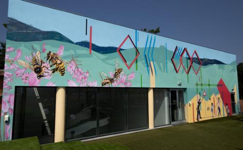 a building with a mural of bees on it at Boticas Hotel Art & SPA in Boticas