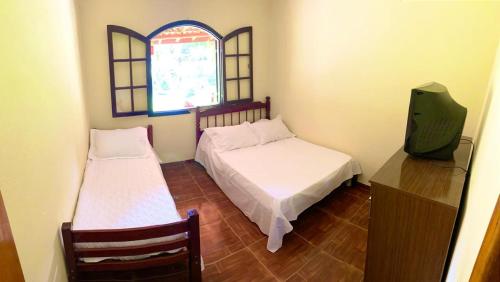 Tempat tidur dalam kamar di Recanto da roça