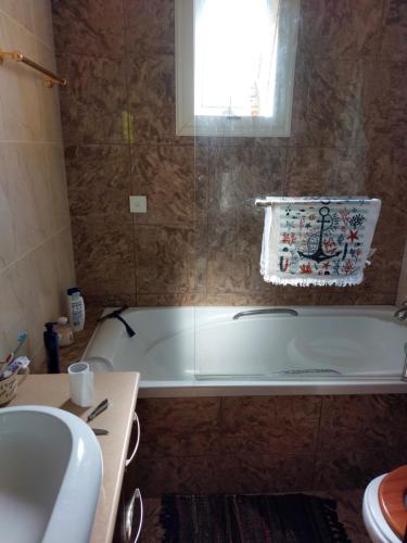 a bathroom with a bath tub and a sink at Danitsea vila in Larnaca