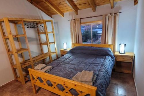 a bedroom with a bed and two bunk beds at Blue House 5 Villa La Angostura in Villa La Angostura