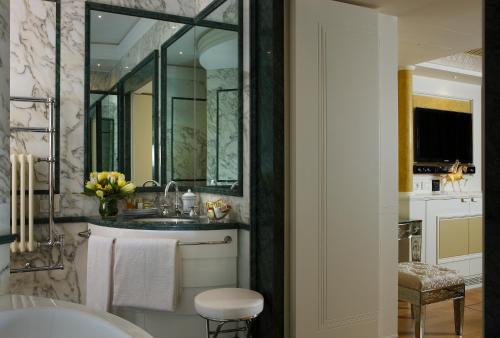 une salle de bain avec un lavabo et un grand miroir dans l'établissement Canaletto Luxury Suites - San Marco Luxury, à Venise