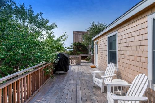 a patio with two chairs and a fence at Huron Hideaway in Ocean Bay Park