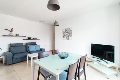 a living room with a table and a couch at Roggia Apartments by Quokka 360 - central flats with parking space in Lugano
