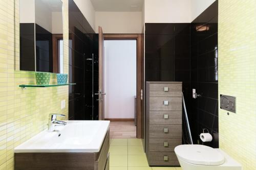 a bathroom with a sink and a toilet at Roggia Apartments by Quokka 360 - central flats with parking space in Lugano