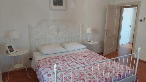 a bedroom with a bed and two tables with lamps at PORT on riva with parking and sea view in Makarska