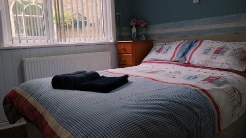 a bed with two pillows on it in a bedroom at Commanders Cabin EV point in Looe