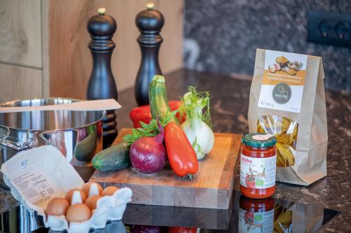 a counter with vegetables on a cutting board with a bag at hubertus dolomites in Fiè