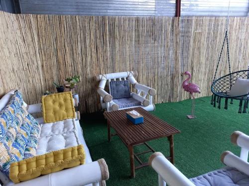 a living room with a couch and a table at ResaLoc - Maison Traditionnelle avec jardin in Saint-André
