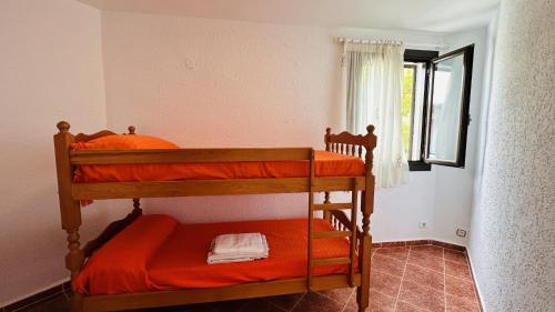 two bunk beds in a room with a window at TRES CARABELAS 249 in Alcossebre
