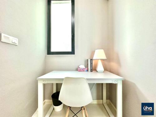 a white desk with a white chair and a lamp at Macrolink Medini by RR JBcity in Nusajaya
