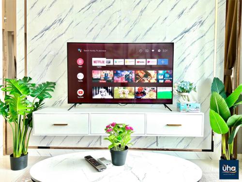 a television on a white dresser in a living room at Macrolink Medini by RR JBcity in Nusajaya