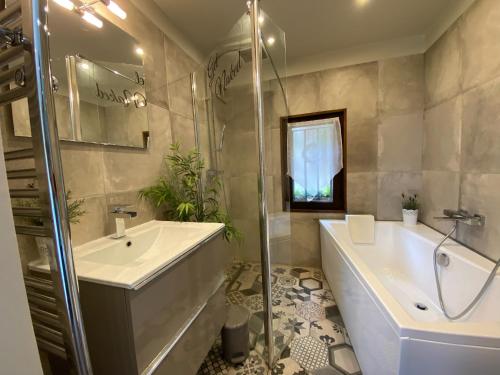 a bathroom with a tub and a sink and a shower at Dieu L'Amour - Molinard in Châteauneuf