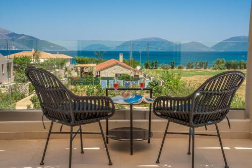 two chairs and a table in front of a window at Claire villa in Sami