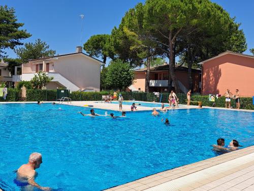 a group of people swimming in a swimming pool at Adriella apartments in Bibione