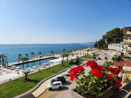 a view of a street with a beach and cars at Hotel Gold in Vlor&euml;