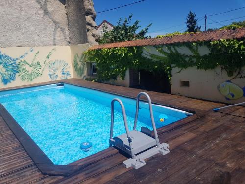 a swimming pool in the middle of a house at Le Miette, family house Sleeps 6 in La Celle-sous-Gouzon